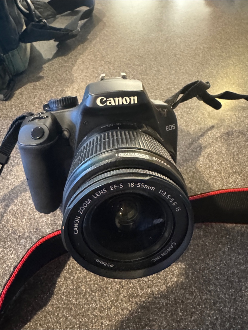 Canon DSLR Camera with Black Body and Red-Trim Strap and Camera Bag